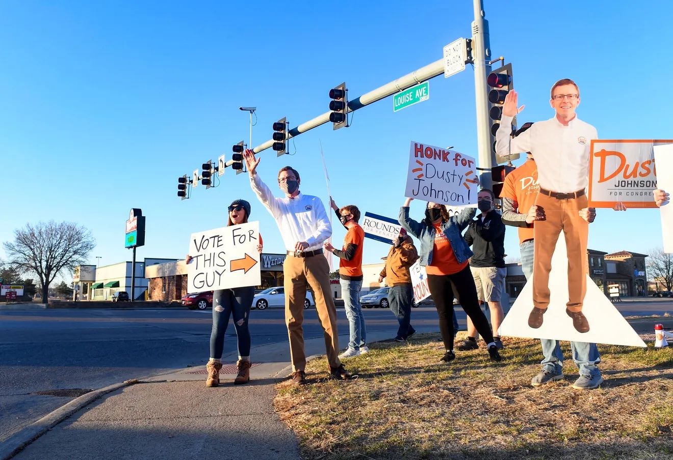 Dusty Johnson waves to supporters