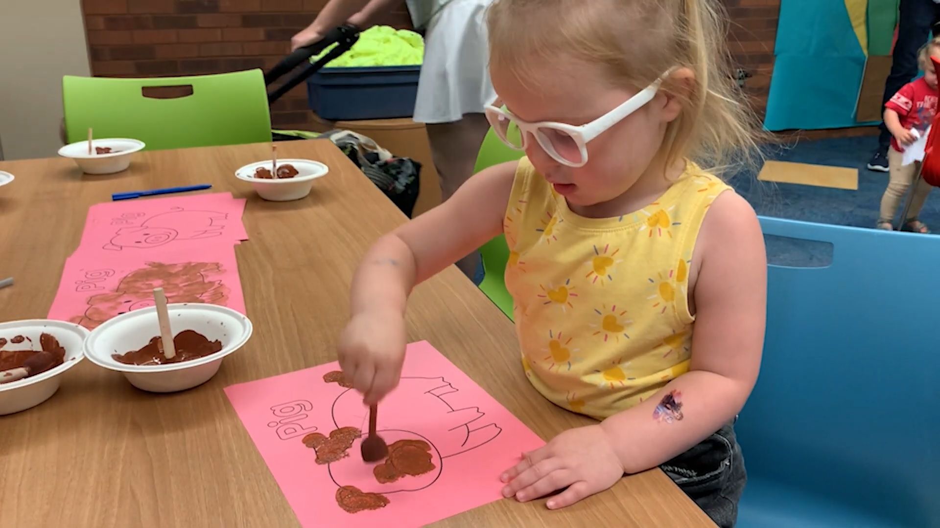 A child draws and paints at the Siouxland Libraries