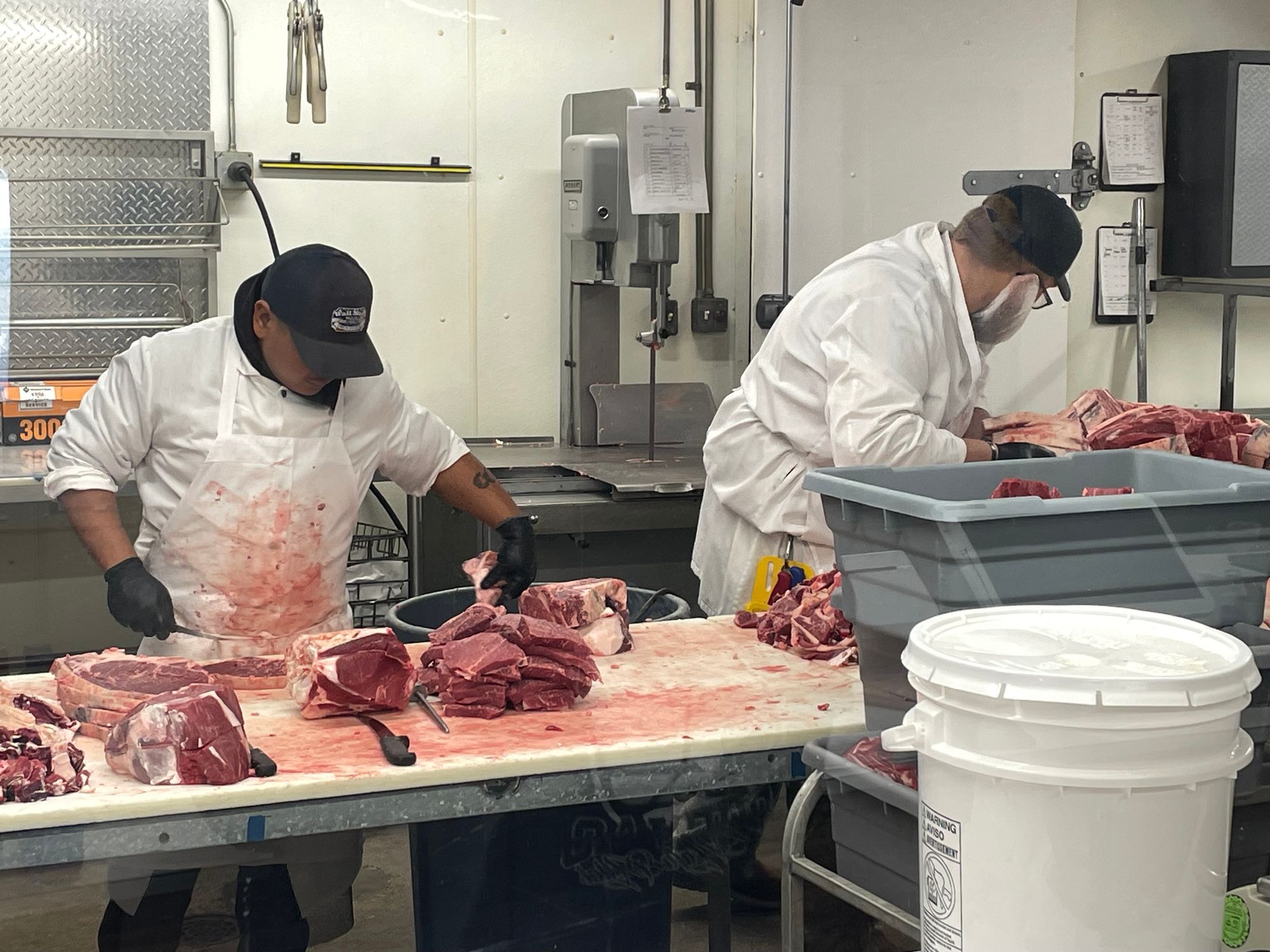 Workers cut and handle beef from a cow supplied by a local rancher at the Wall Meat Processing plant in Wall, South Dakota.