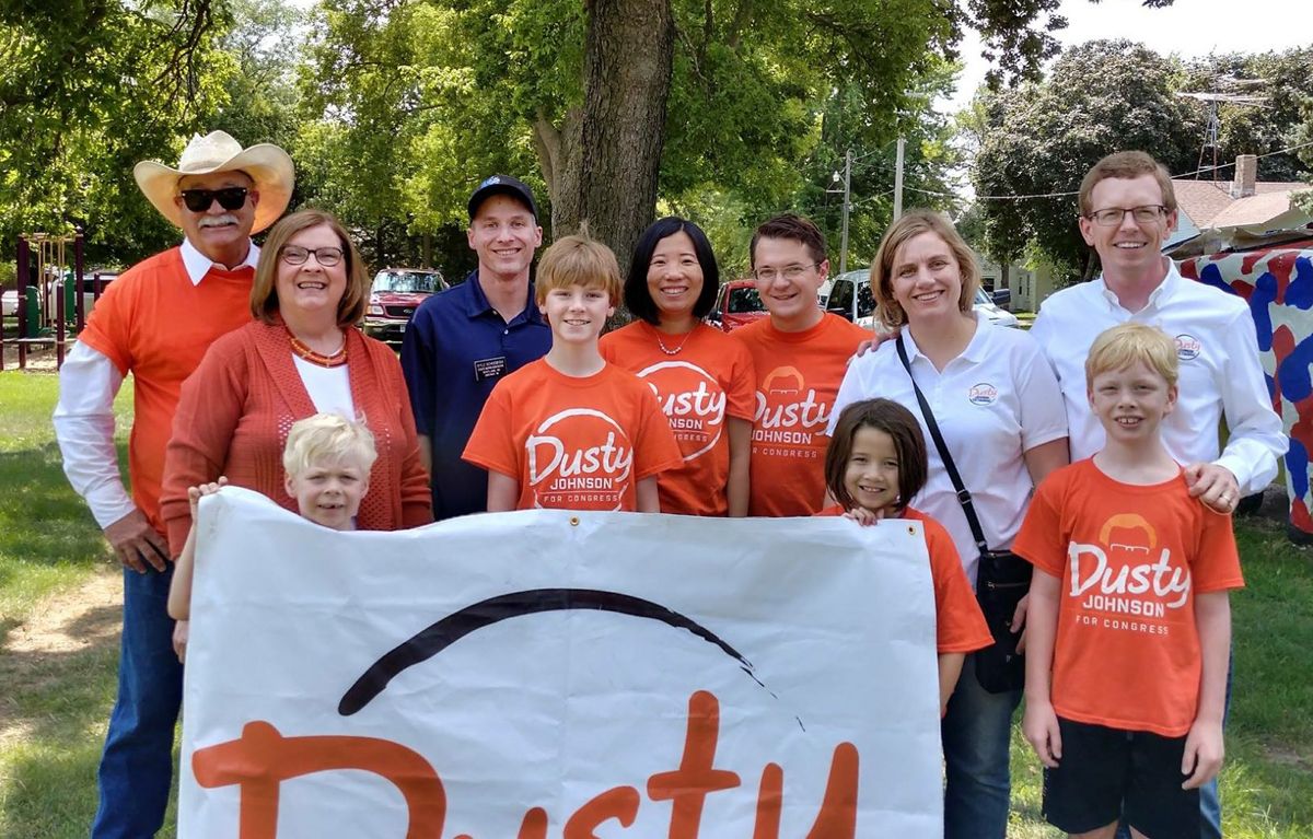 Dusty Johnson poses with family members and supporters at a parade in Scotland, South Dakota.
