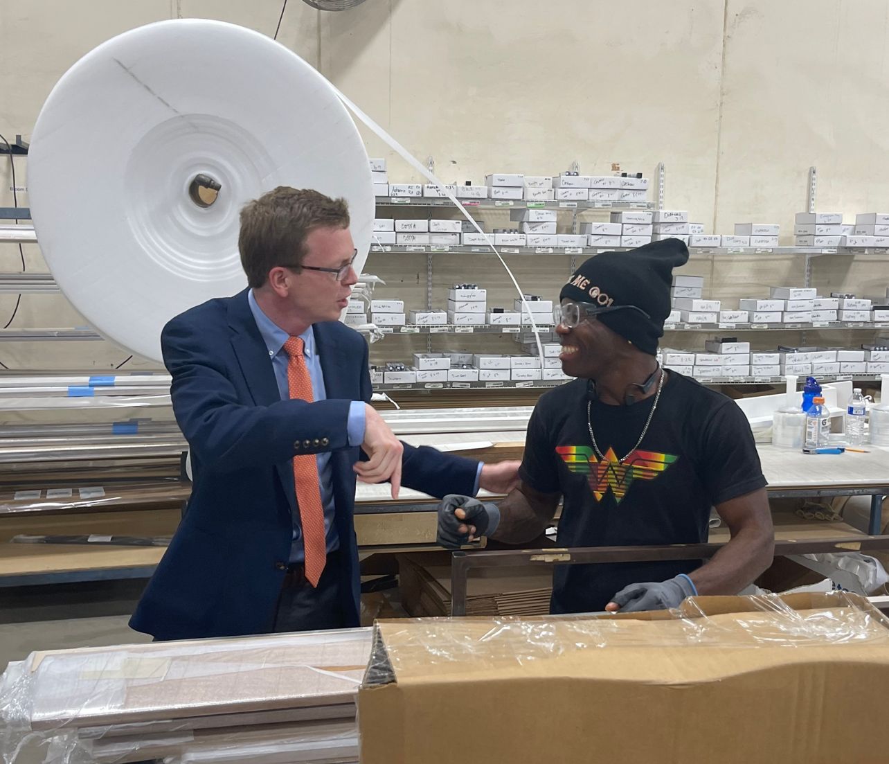 Dusty Johnson speaks with an employee Aug. 23 at Showplace Cabinetry in Harrisburg