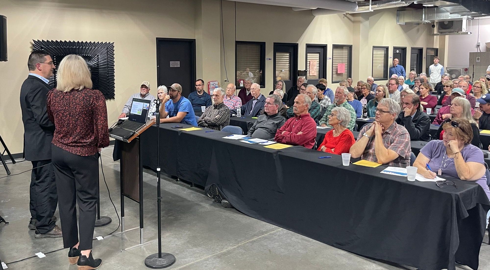 Rick Weible and Jessica Pollema give a presentation to Concerned Citizens of Lincoln County in front of a crowd of dozens