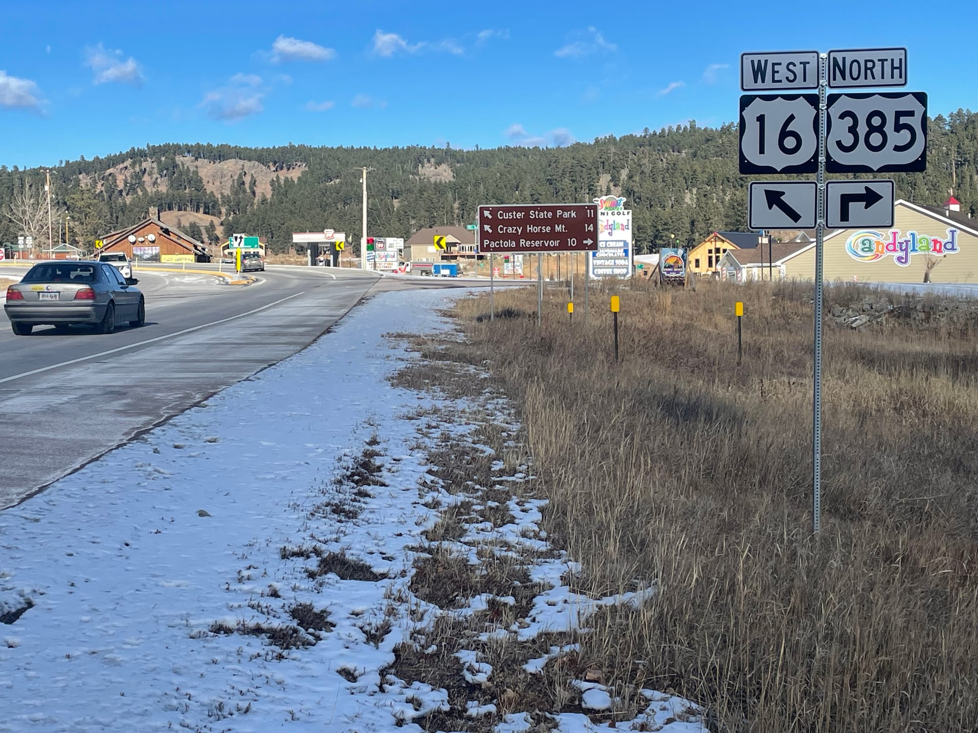 A car drives on Highway 16 near Highway 385 in Black Hills, South Dakota