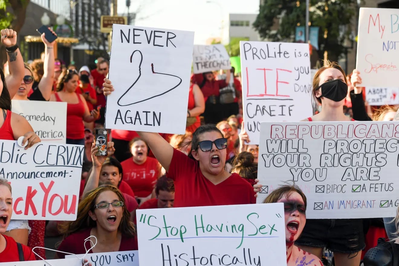 Protesters hold signs during an abortion rally in Sioux Falls