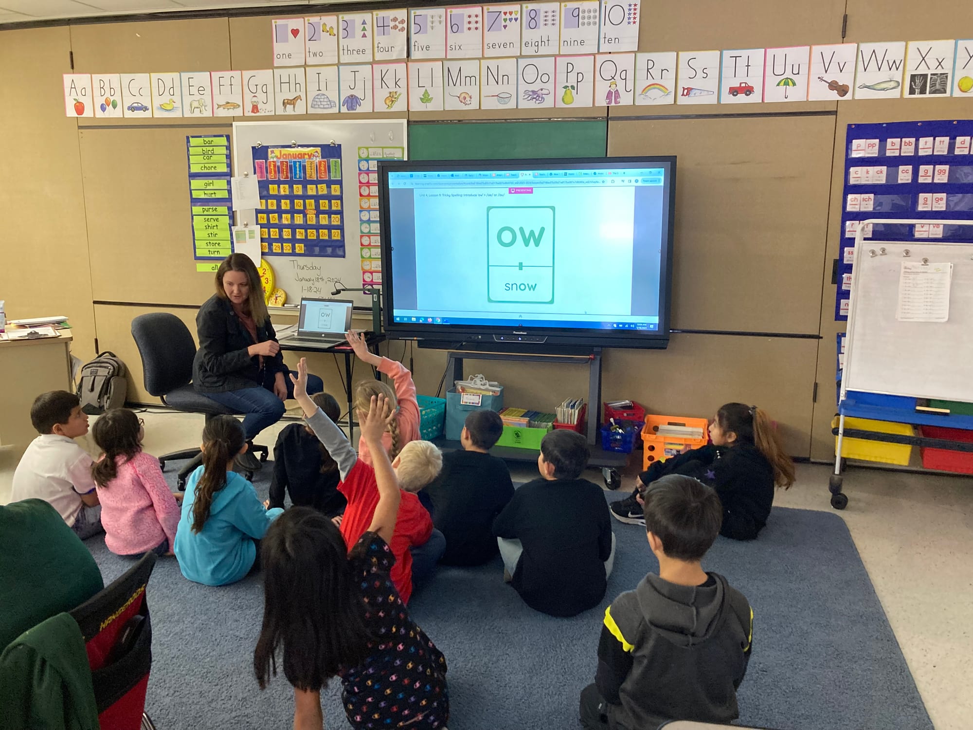  A teacher at Westside Elementary School in Sisseton, S.D., helps students read through the use of phonics-based literacy 