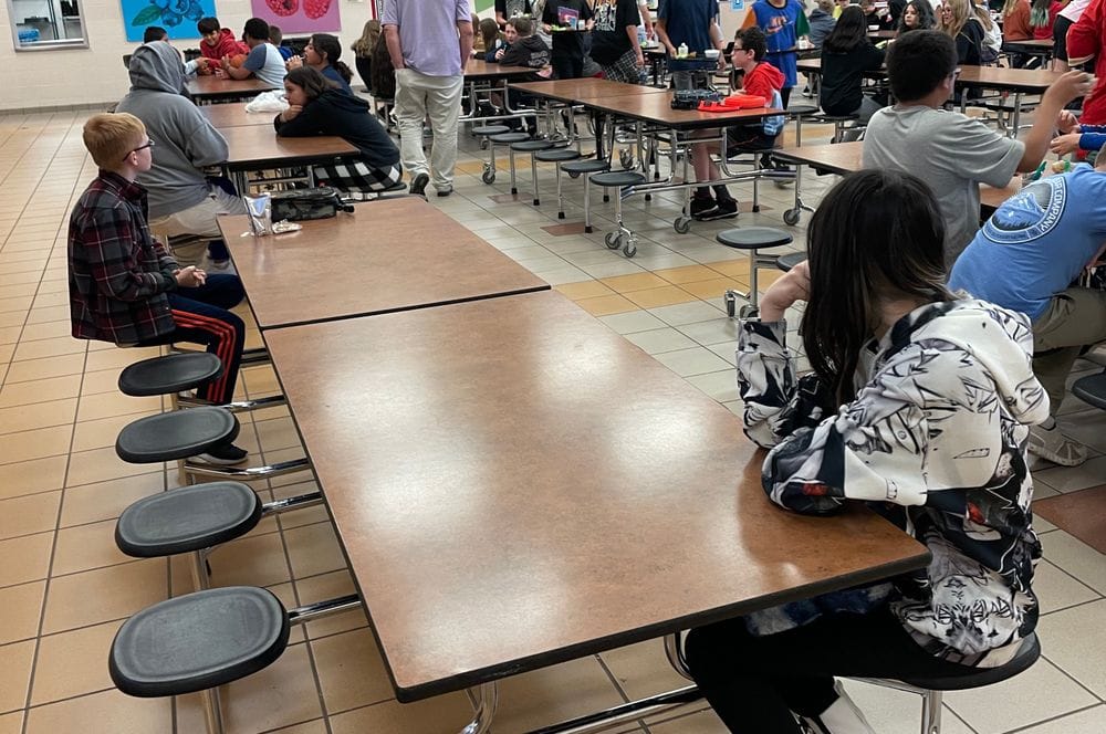 Students sit at a table during lunch at the East Middle School in Rapid City. 