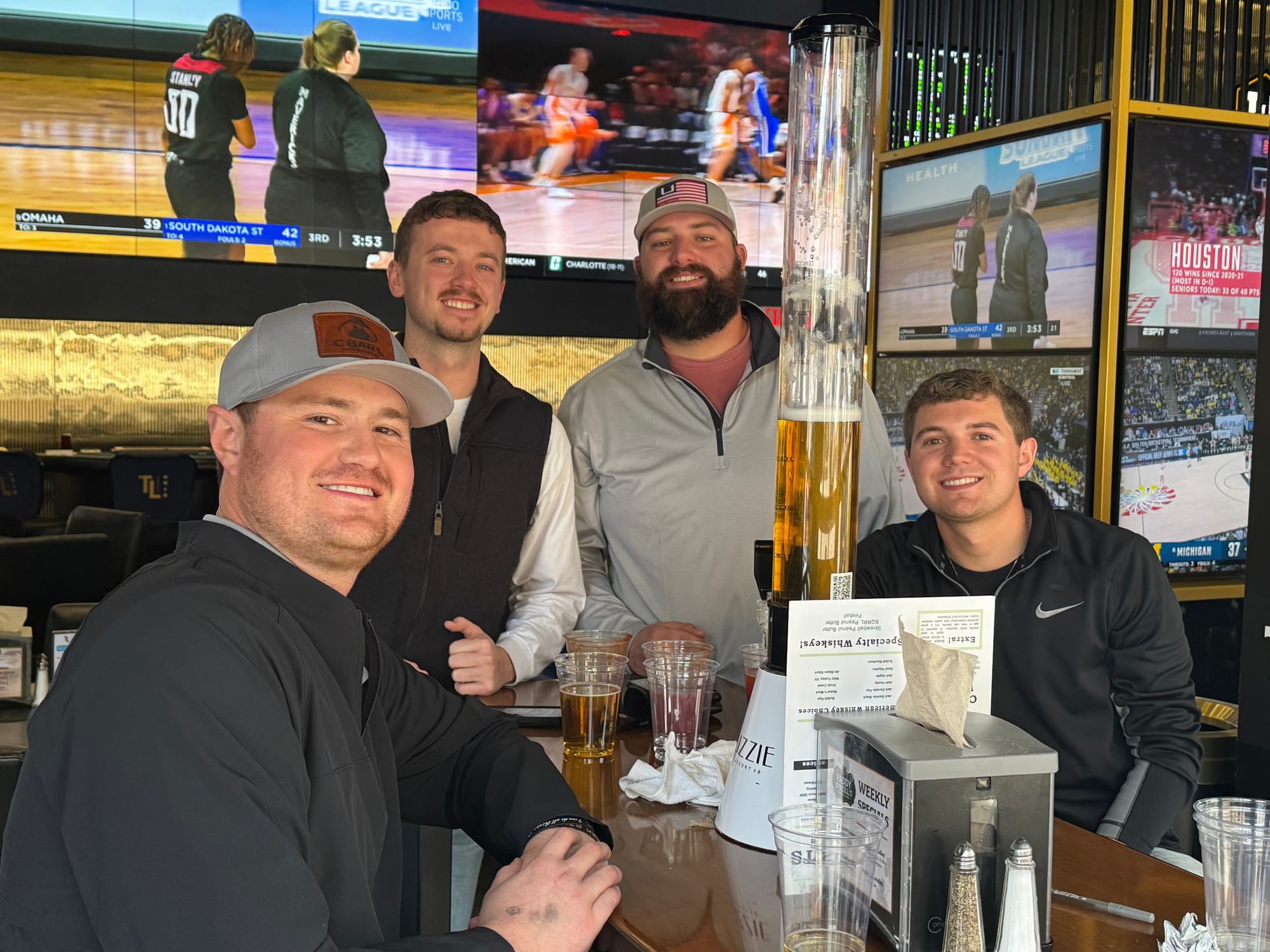 Four men from Colorado pose for a photo at a sports betting site in Deadwood, South Dakota.