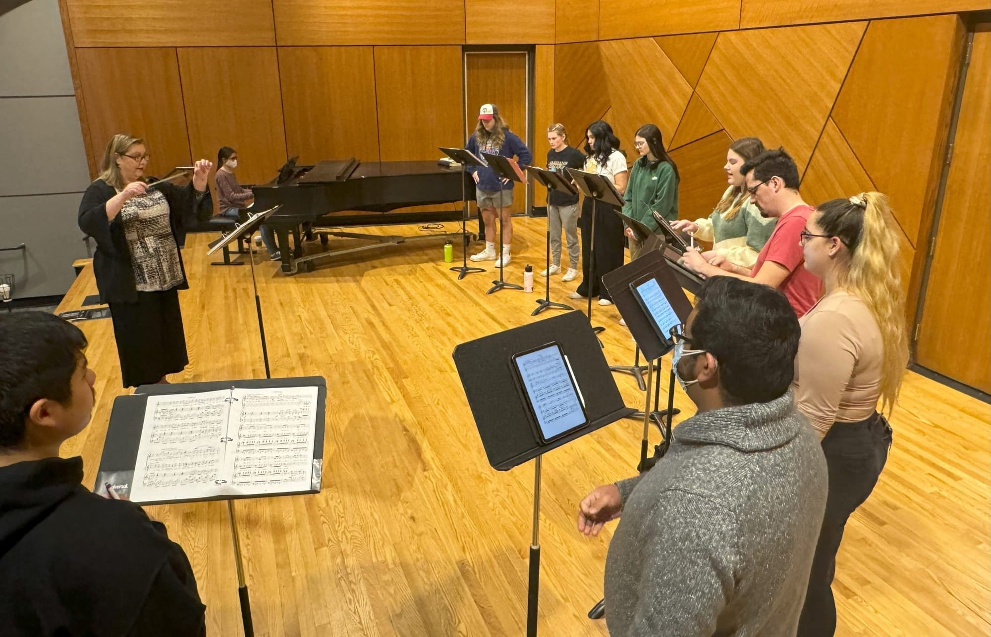 Students rehearse music on stage at the University of South Dakota