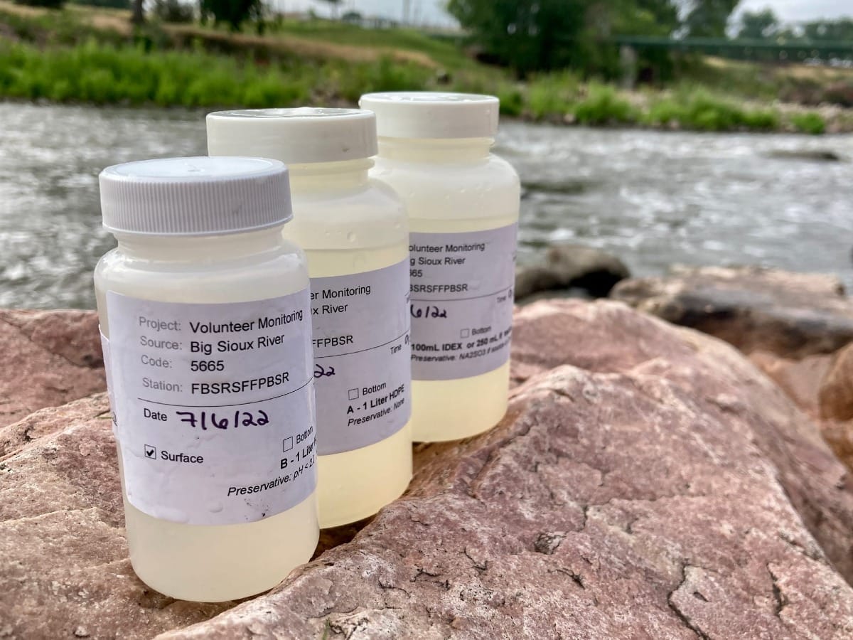 Water testing samples on top of a rock at the Big Sioux River in Sioux Falls, South Dakota