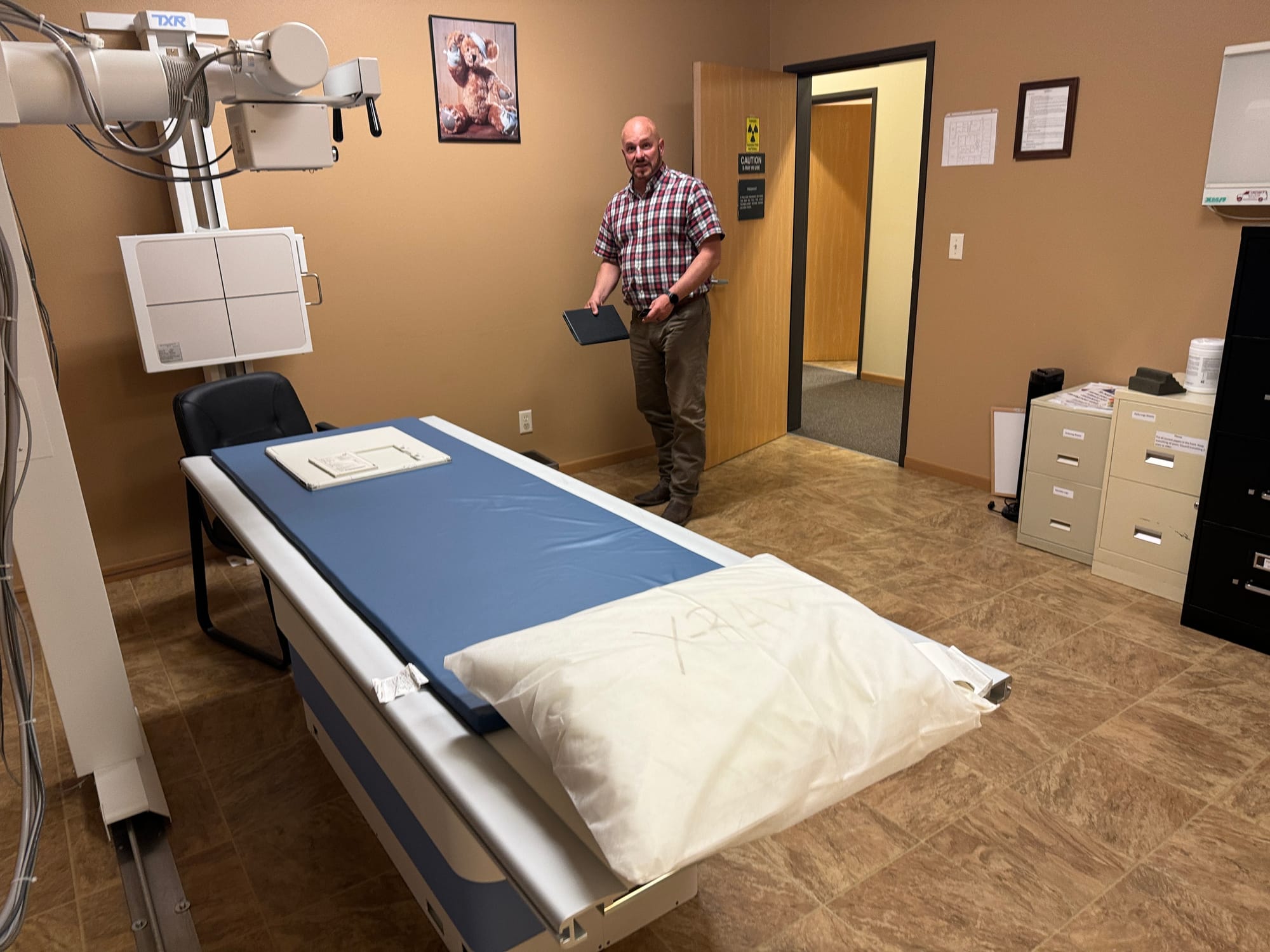 Horizon Health CEO Wade Erickson shows off an X-ray machine at the system's clinic in Martin, S.D. 