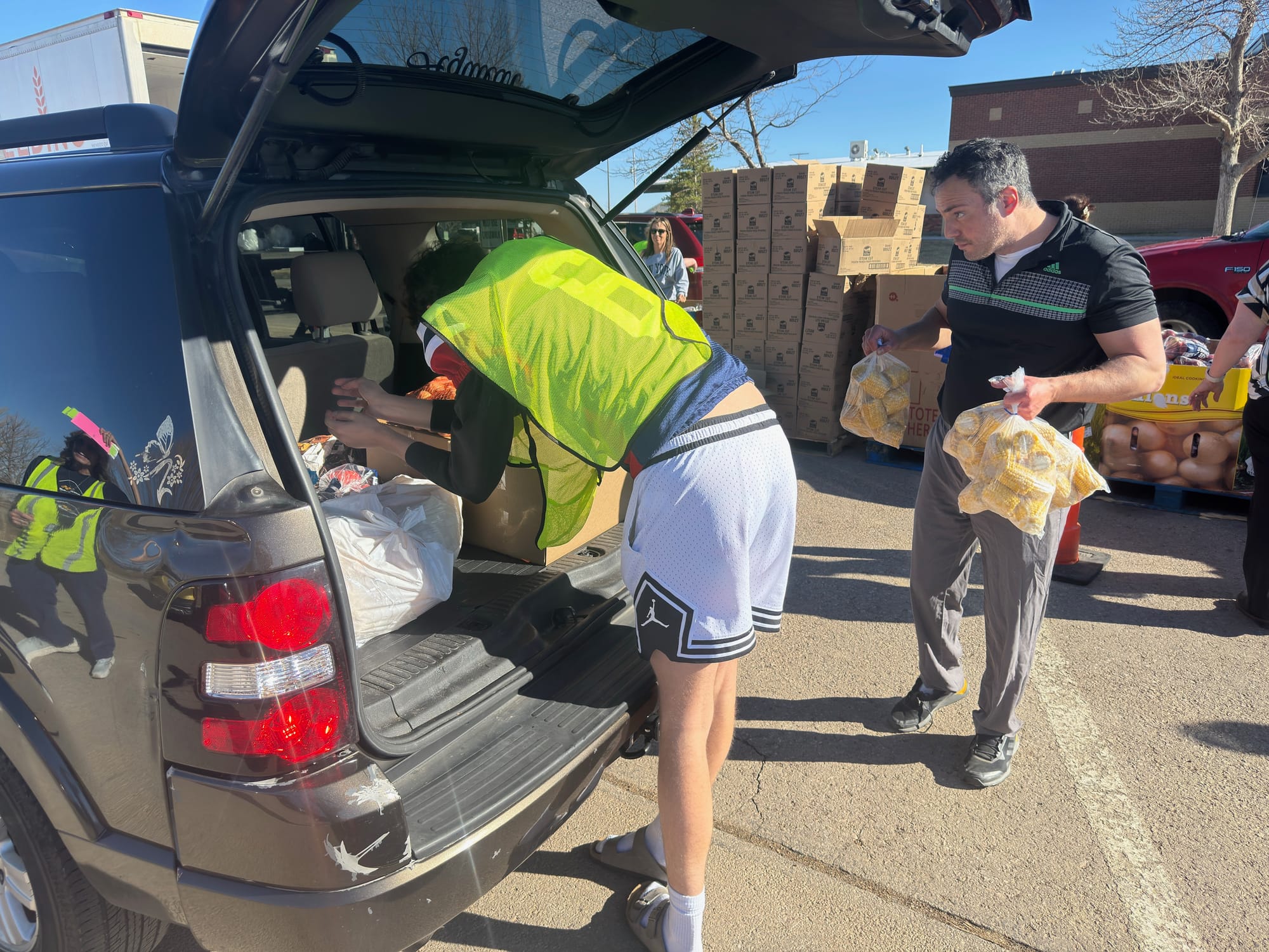 Volunteers load a car with food at a Feeding South Dakota mobile food bank