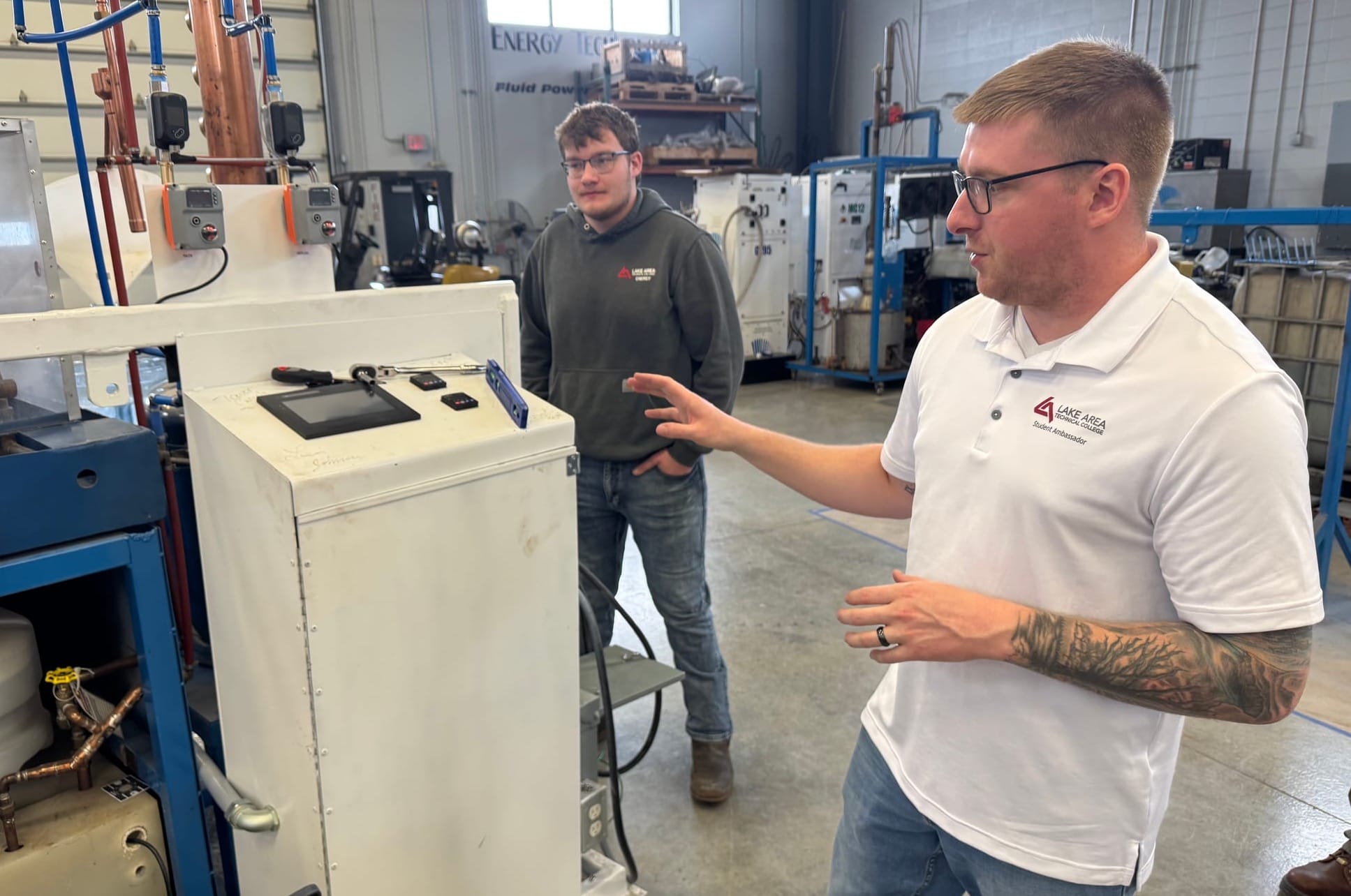 Lake Area Technical College students Nathan Kittleson, left and Nathaniel Bekaert discuss components of energy systems at the campus in Watertown, S.D., on April 10, 2025.
