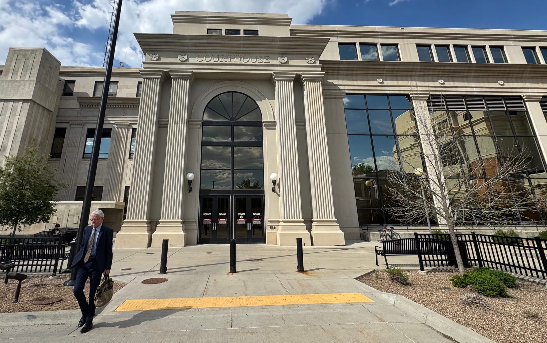 An attorney exits the Pennington County Courthouse in Rapid City, S.D.
