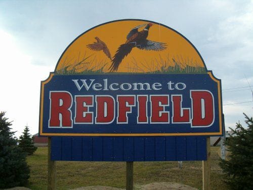A 'Welcome to Redfield' sign.