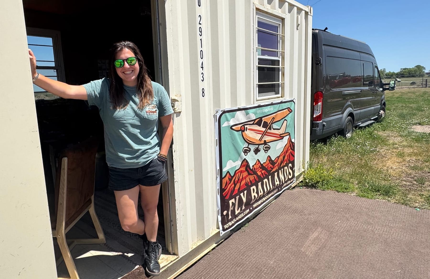 Ana Komar, owner and operator of Fly Badlands scenic flight tours, poses for a photo at her business