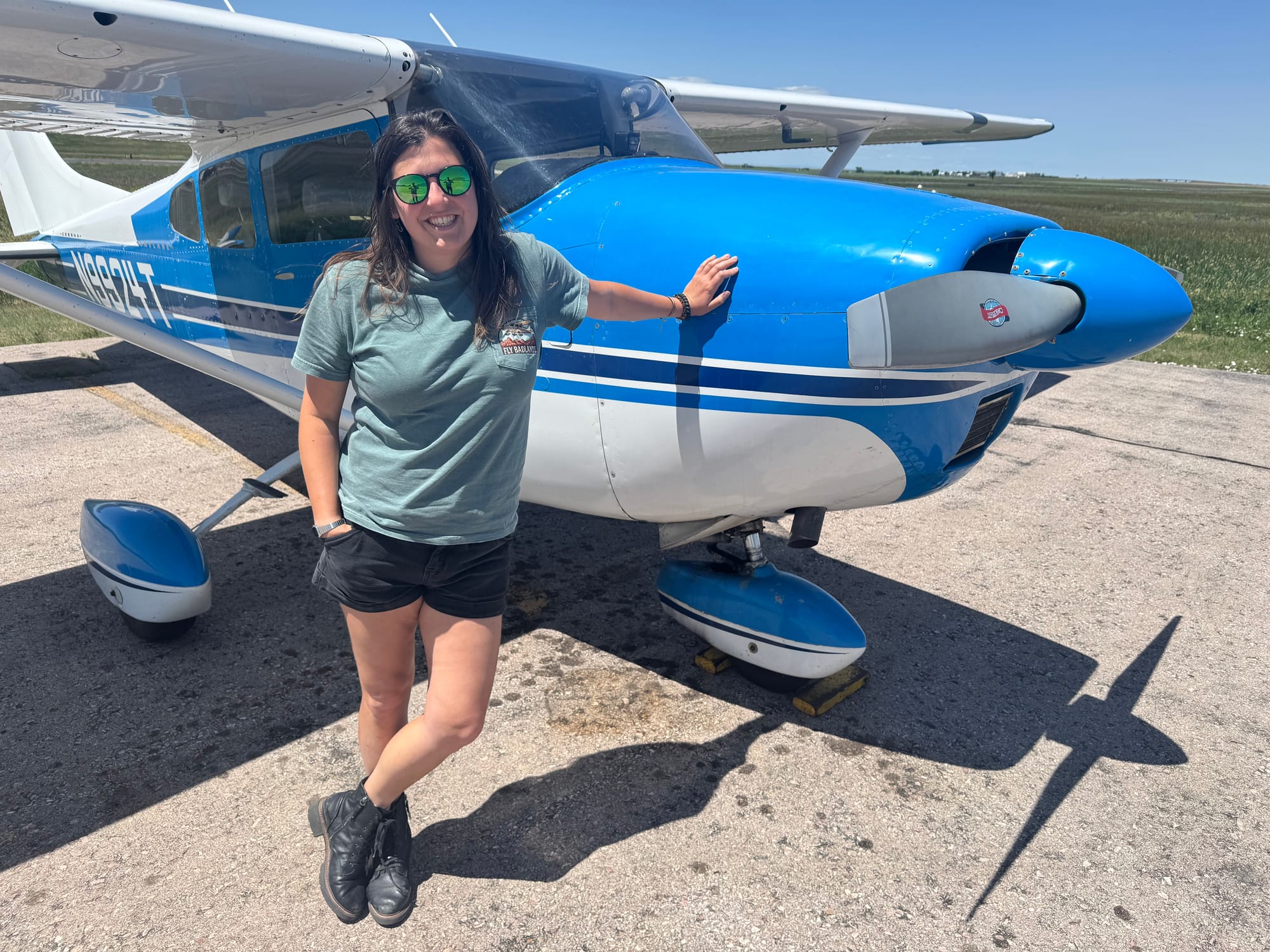 Ana Komar and the Cessna she pilots to take tourists over the South Dakota Badlands while parked at the Wall, S.D., airport on June 23, 2025.