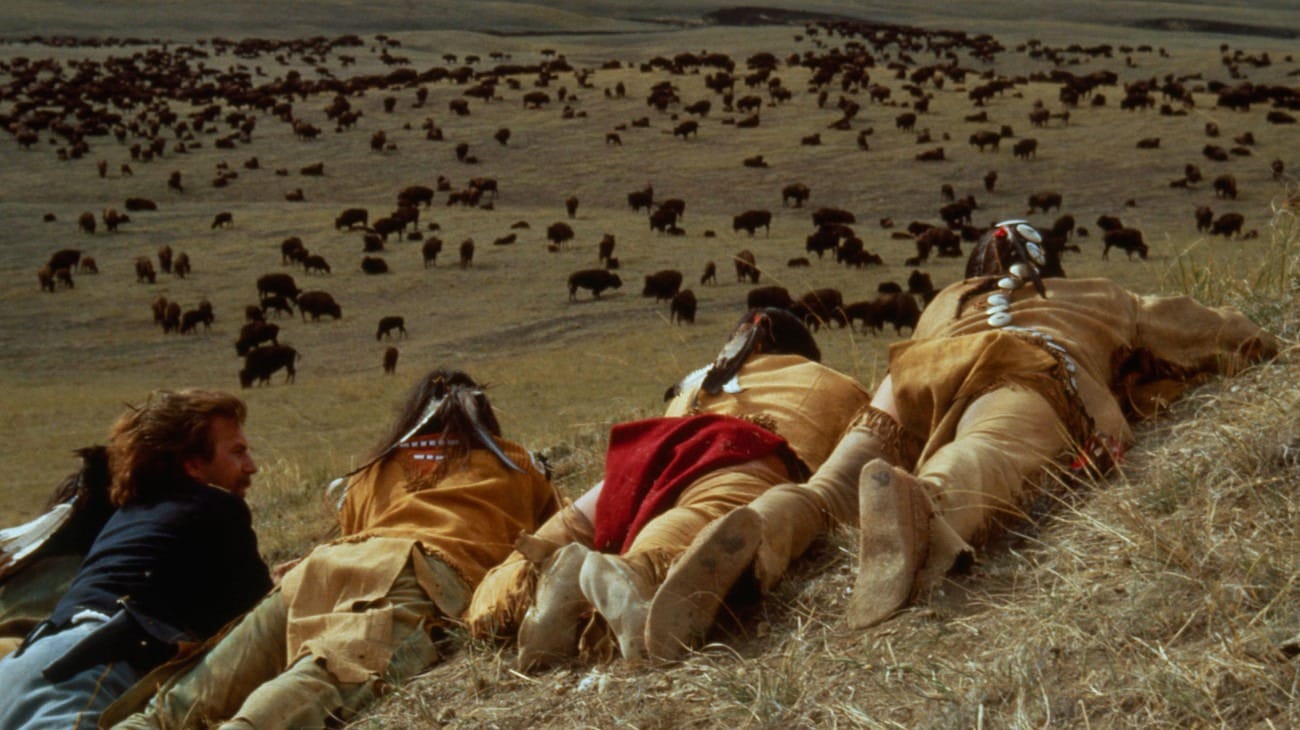 Kevin Costner (left) and other actors overlooking a buffalo herd from a bluff in a 'Dances With Wolves' scene, shot in western South Dakota, 1990.