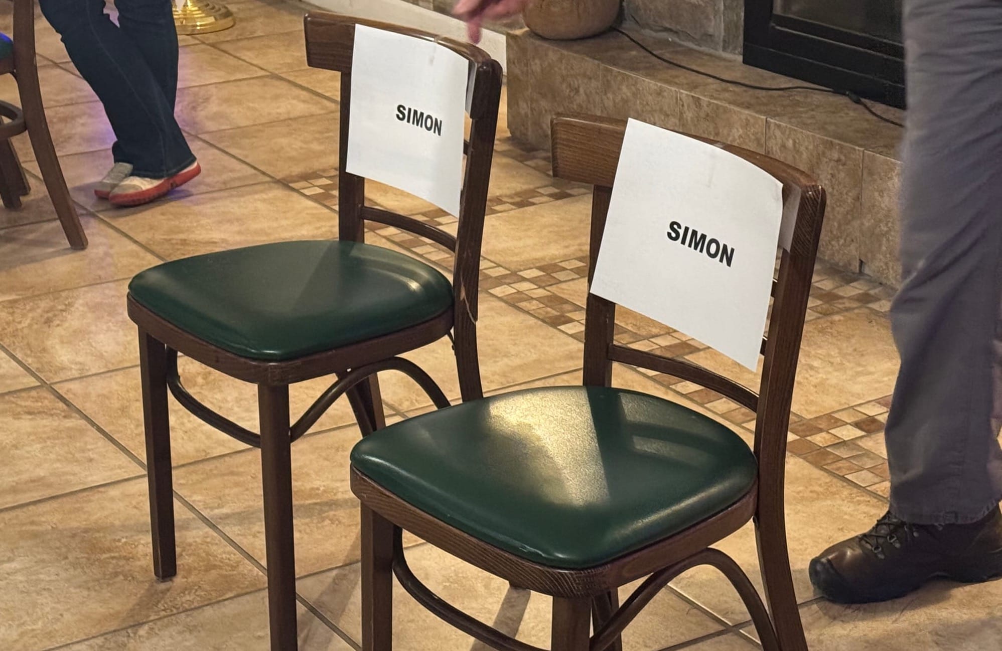 Two chairs set aside for representatives of Simon Contractors, which is planning a limestone mine in Piedmont, S.D., sit empty after company representatives declined to attend a Nov. 20, 2025, community meeting about the mine held at Elk Creek Resort. 