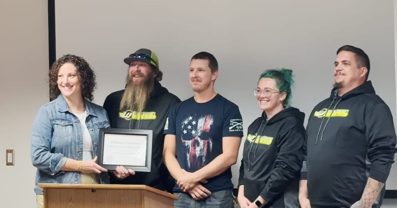 Coworkers from Wheelhouse Auto Body & Paint, where treatment court graduate "Dylan" (third from the left) works, came to the graduation ceremony to support him