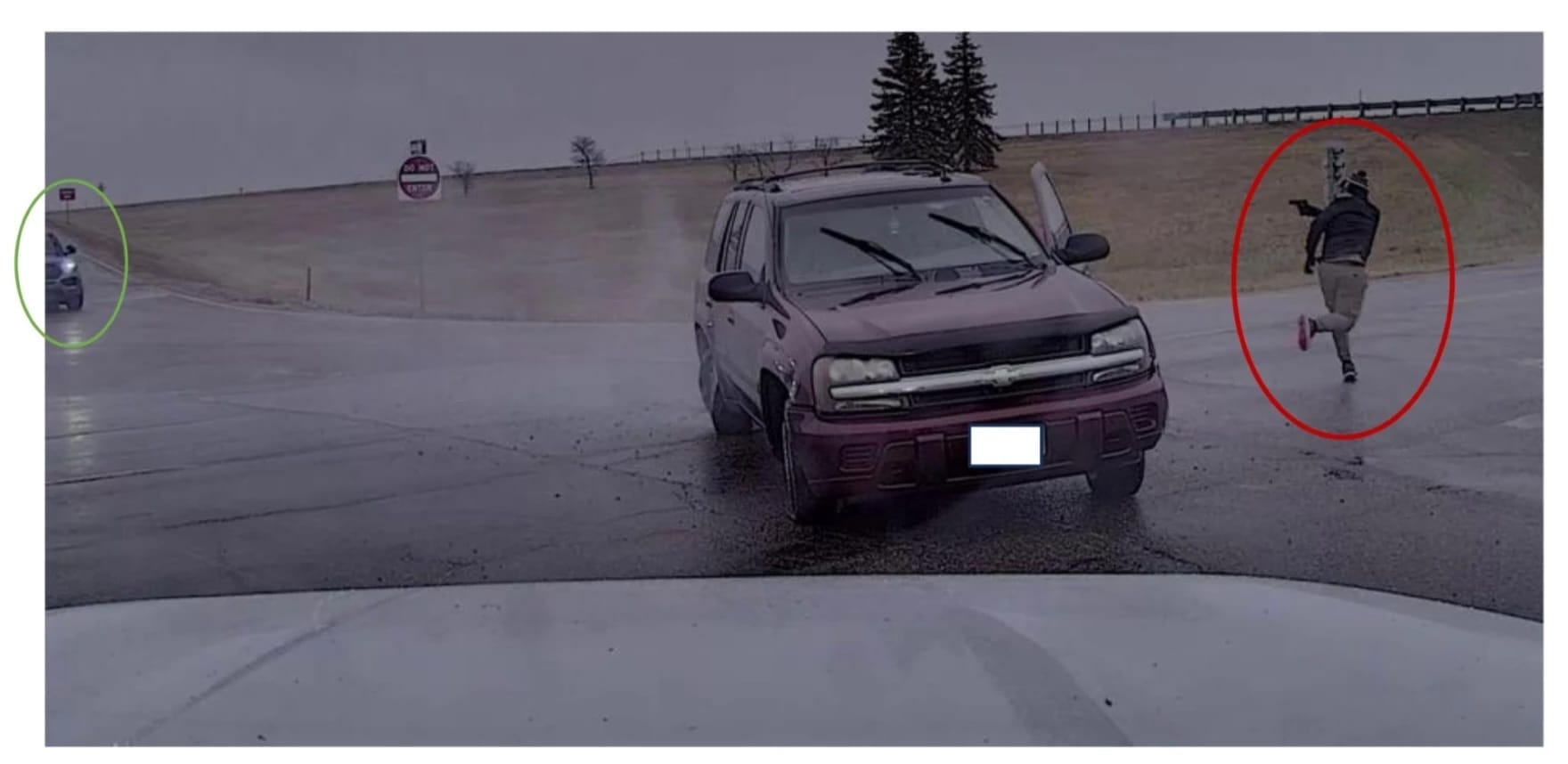 This screenshot from a South Dakota Highway Patrol dashboard camera shows an officer-involved shooting incident on April 1, 2025.