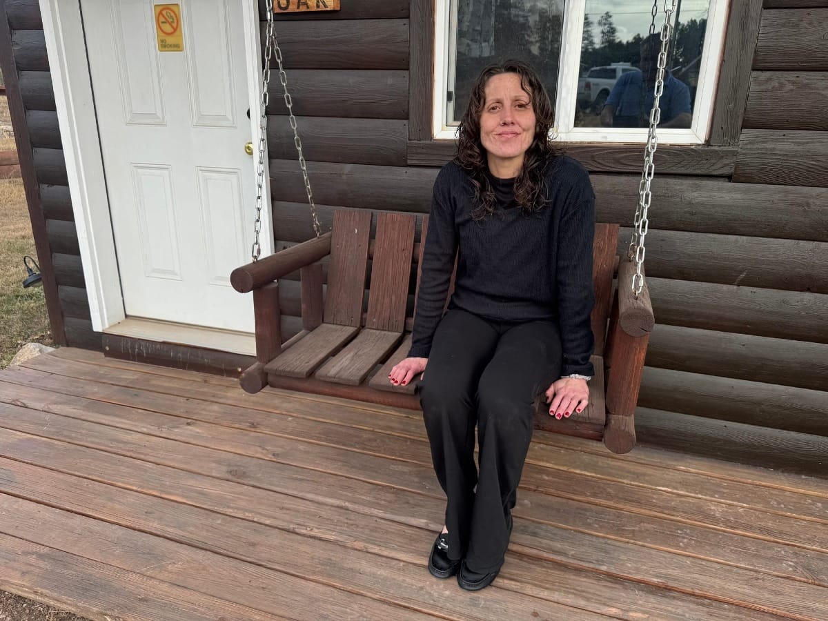 Kristen Kilcoin, owner of Three Forks Campground near Hill City, S.D., on the patio of a rental cottage at the resort on Jan. 6, 2026. (Photo: Bart Pfankuch / South Dakota News Watch)