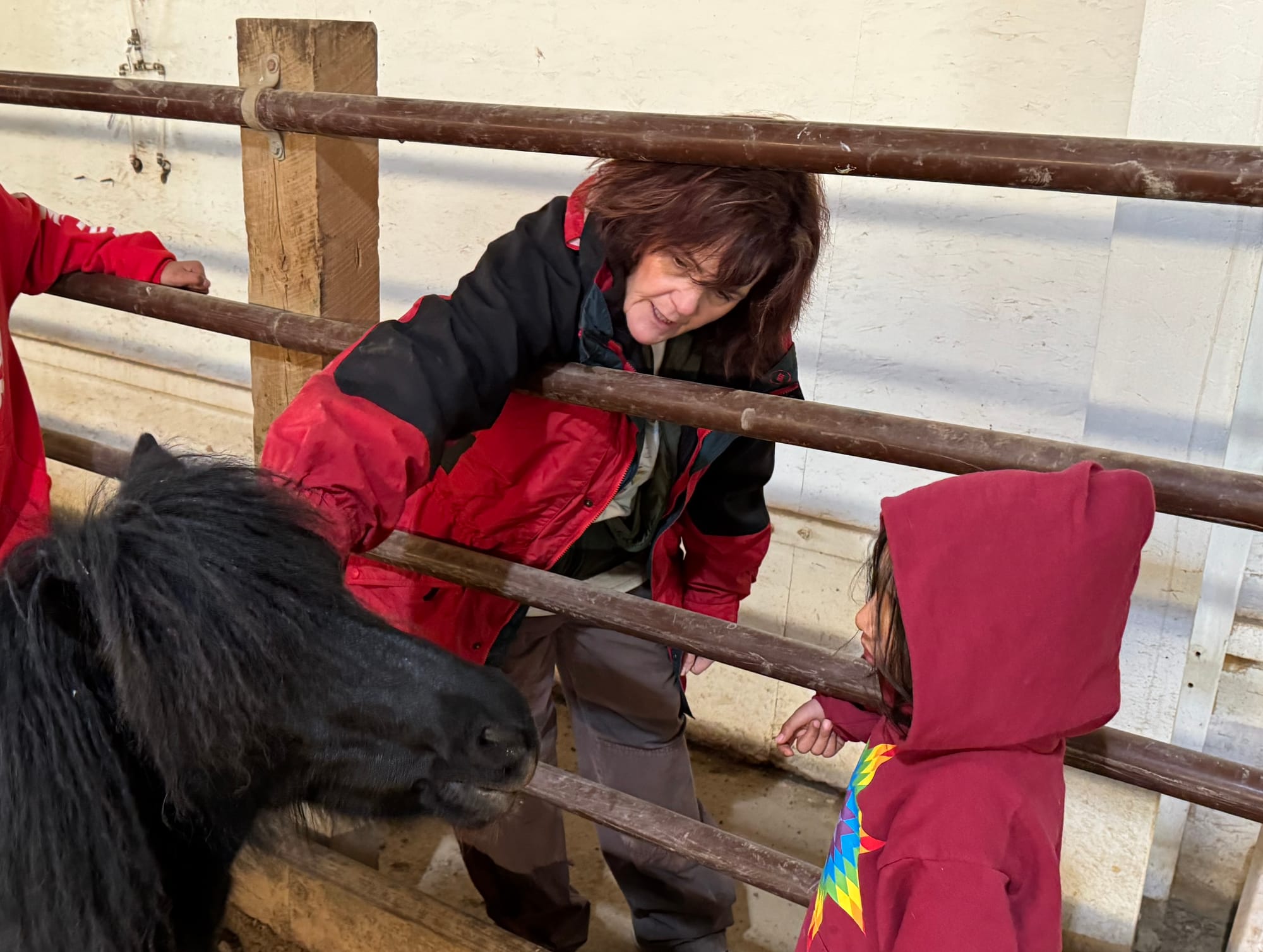 Bridget Williams introduces a child to a horse at Red Horse Healing in Rapid Valley, S.D., on Feb. 21, 2026.