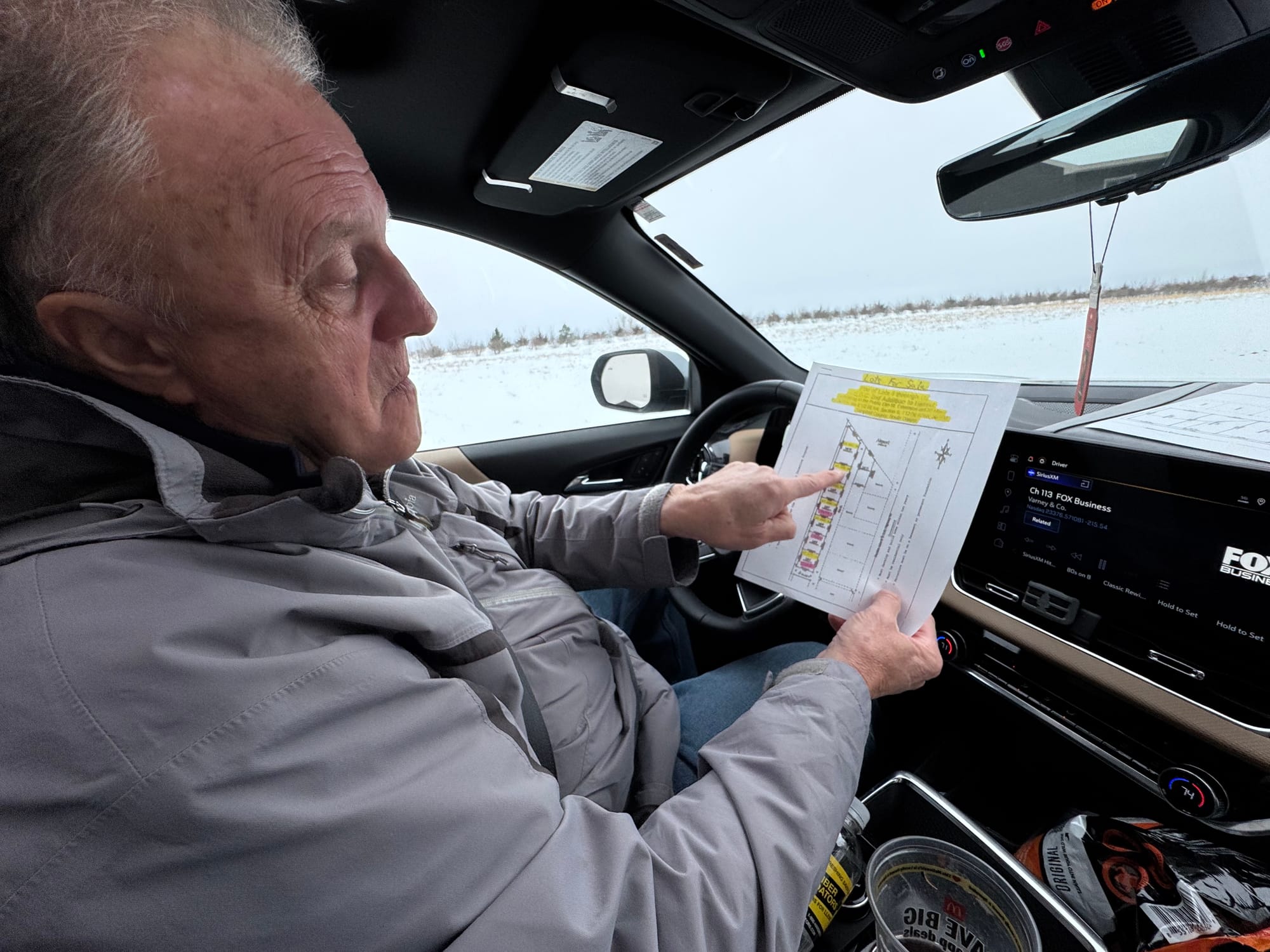 Dick Werner of Herreid, S.D., shown on Feb. 3, 2026, looks at a plat map while driving around the town.
