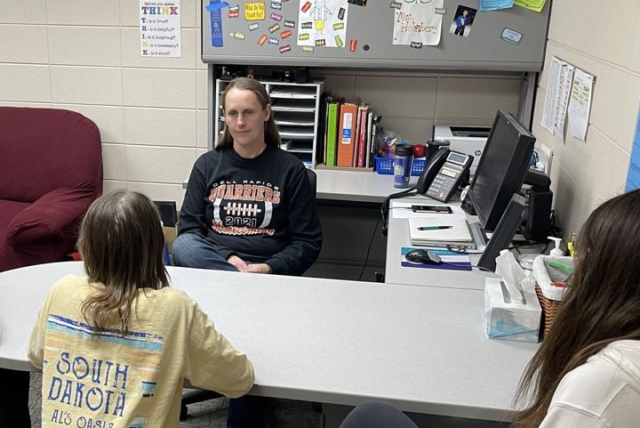 A Dell Rapids High School counselor talks to a student at the school in her office.