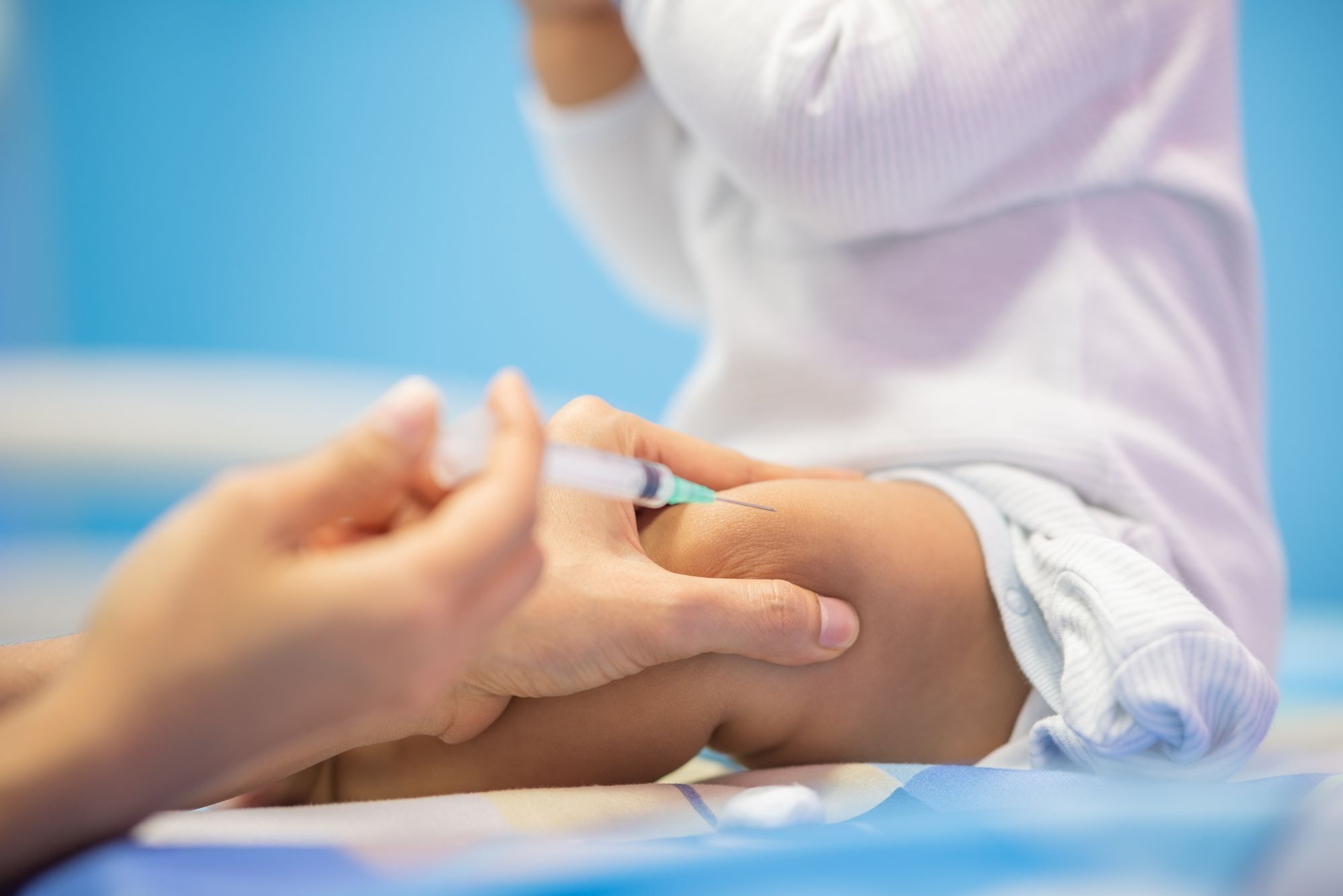 A baby receives a vaccine