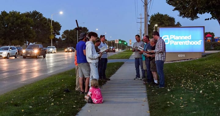 A group of men protest outside of Planned Parenthood in Sioux Falls