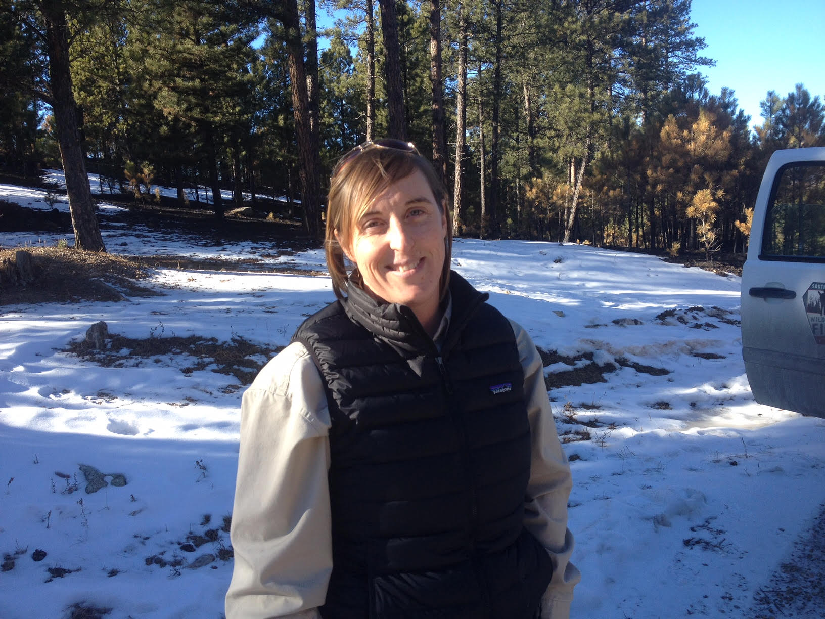 Rochell Plocek standing in snowy woods.